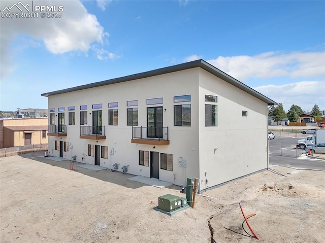 241 N Front St Unit 101, Monument, CO 80132 - back of property featuring a balcony, stucco siding, and fence