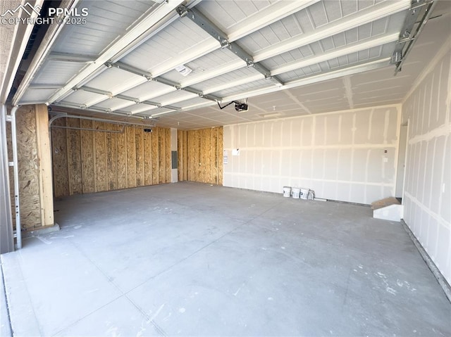 garage with a garage door opener and wooden walls