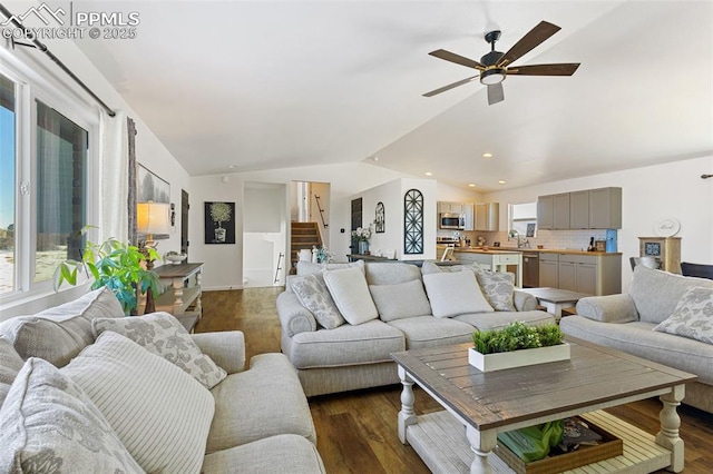 living room featuring ceiling fan, lofted ceiling, dark hardwood / wood-style flooring, and sink