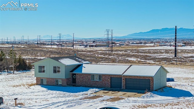 view of front of house with a mountain view and a garage