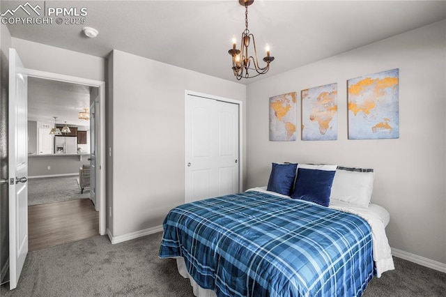 bedroom featuring a notable chandelier, carpet floors, and stainless steel fridge