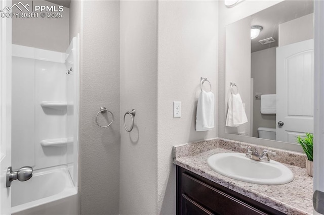 full bathroom with shower / bath combination, vanity, and toilet