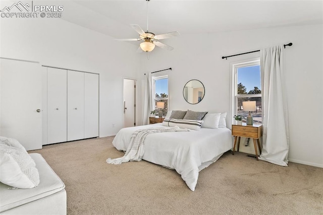 carpeted bedroom featuring ceiling fan, lofted ceiling, and multiple windows