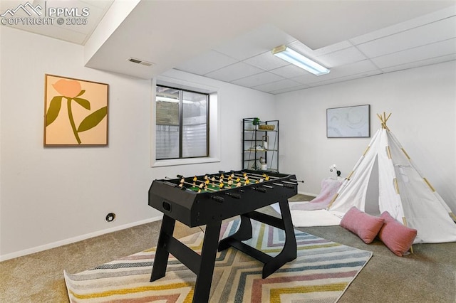 game room with carpet floors and a paneled ceiling