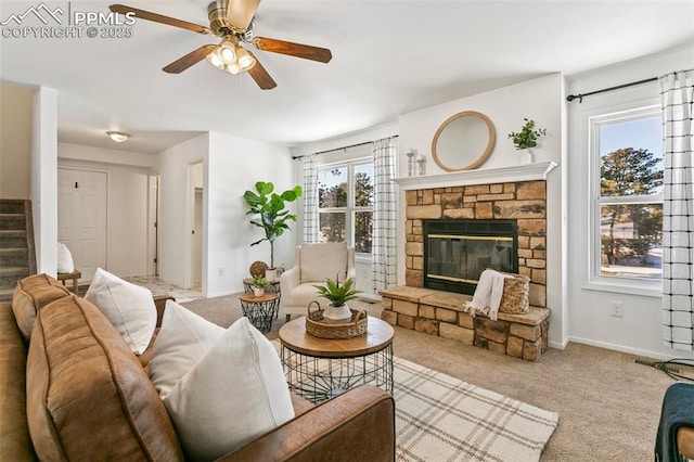 living room with ceiling fan, light colored carpet, plenty of natural light, and a fireplace