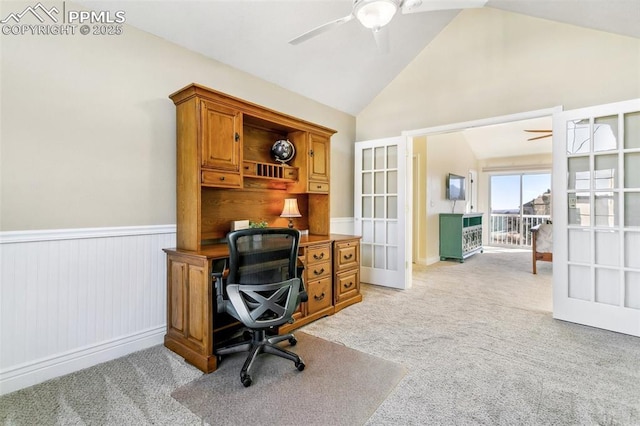 home office featuring lofted ceiling, light colored carpet, french doors, and ceiling fan