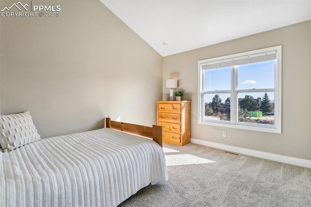 carpeted bedroom featuring lofted ceiling