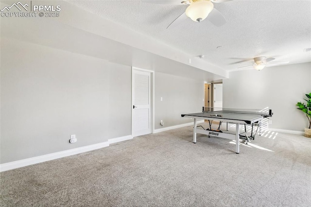 game room featuring ceiling fan, light colored carpet, and a textured ceiling