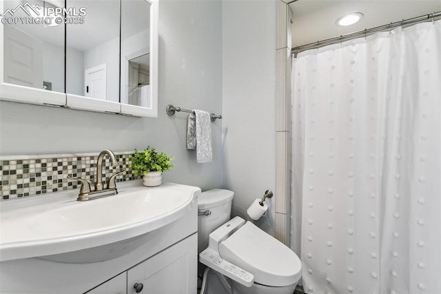 bathroom featuring vanity, toilet, a shower with shower curtain, and backsplash