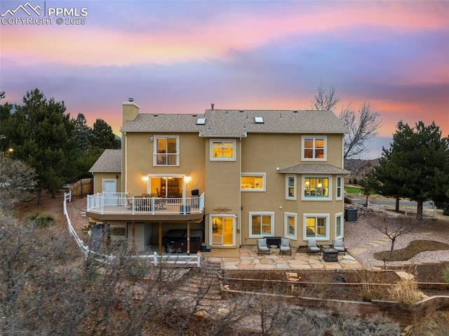 back house at dusk with a patio