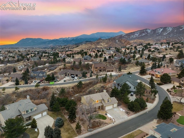 aerial view at dusk featuring a mountain view