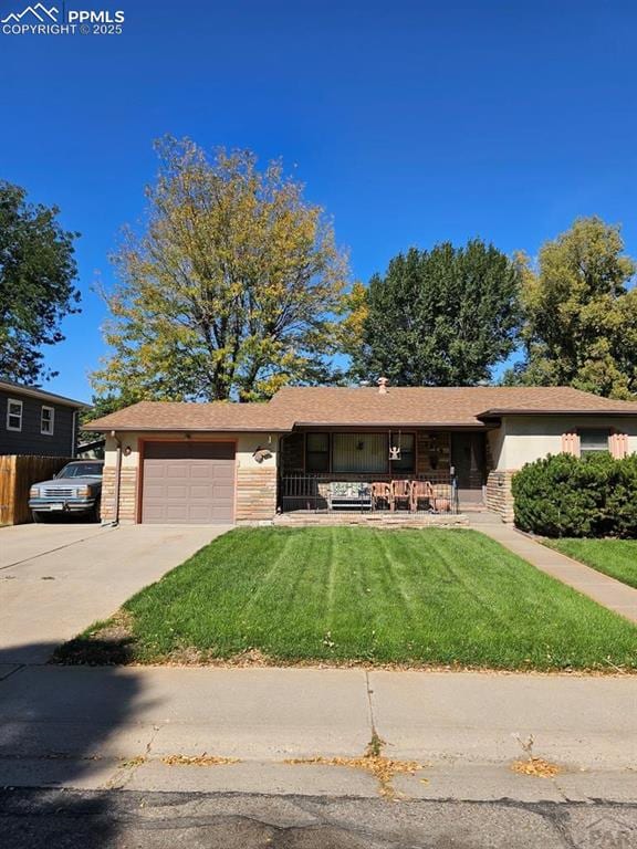 view of front of home featuring a garage and a front lawn