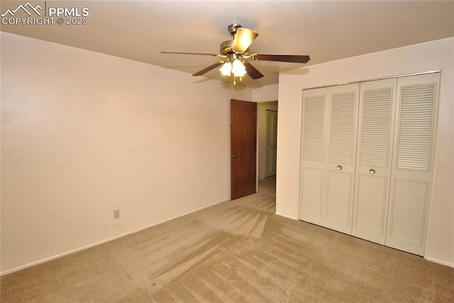 unfurnished bedroom with light colored carpet, a closet, and ceiling fan