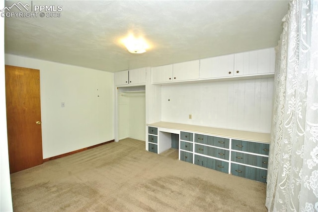 unfurnished bedroom featuring a closet and light carpet