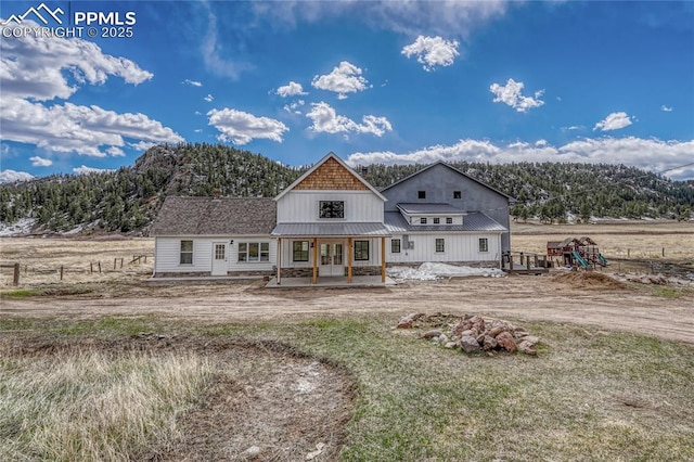 1636 Lakemoor Dr, Florissant, CO 80816 - rear view of property featuring french doors, a standing seam roof, fence, and metal roof