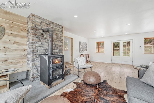 1636 Lakemoor Dr, Florissant, CO 80816 - living area with wood-type flooring, baseboards, a wood stove, and a wealth of natural light