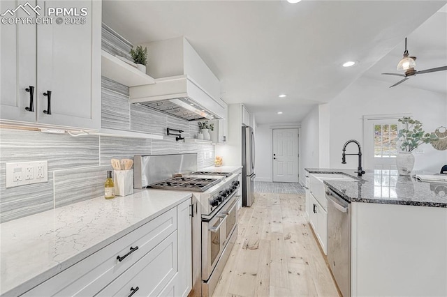1636 Lakemoor Dr, Florissant, CO 80816 - kitchen featuring custom range hood, white cabinets, a sink, and appliances with stainless steel finishes