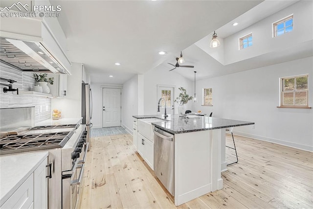 1636 Lakemoor Dr, Florissant, CO 80816 - kitchen with white cabinetry, a breakfast bar, appliances with stainless steel finishes, and a ceiling fan