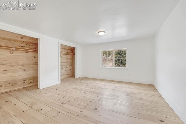 1636 Lakemoor Dr, Florissant, CO 80816 - empty room with baseboards, wooden walls, and hardwood / wood-style floors