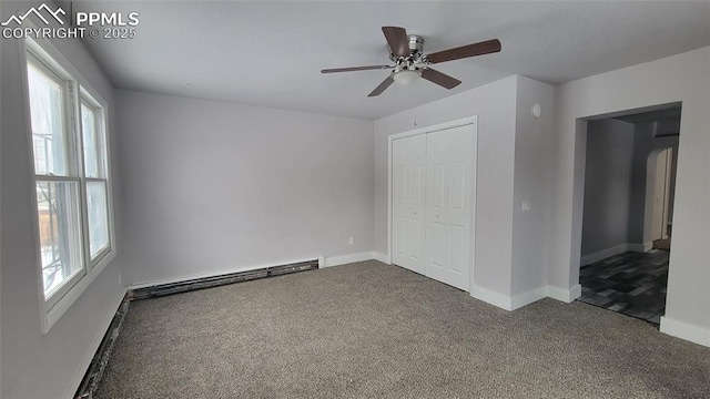 unfurnished bedroom with a baseboard heating unit, a closet, ceiling fan, and carpet flooring