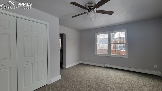 unfurnished bedroom featuring carpet, a baseboard heating unit, ceiling fan, and a closet