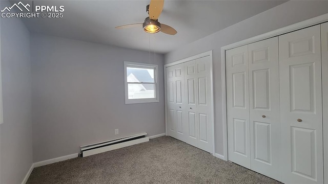 unfurnished bedroom with a baseboard radiator, carpet, two closets, and ceiling fan