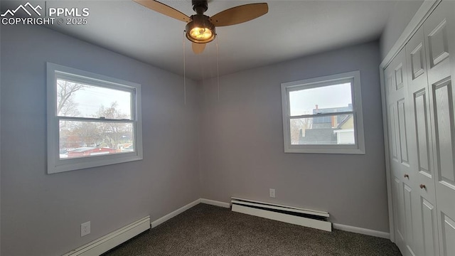 carpeted empty room with baseboard heating and ceiling fan