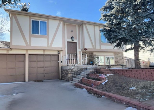 view of front of property with a garage, concrete driveway, and stucco siding