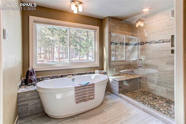 bathroom featuring separate shower and tub