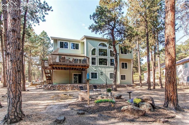 back of property featuring a wooden deck