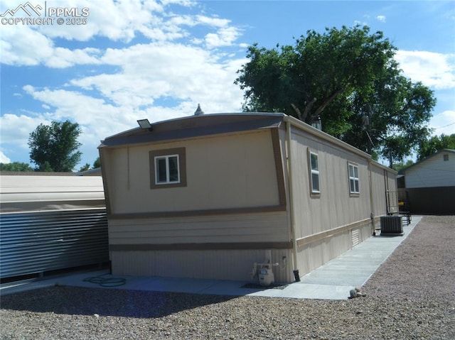 view of side of property featuring central air condition unit