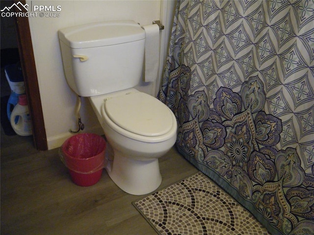 bathroom with a shower with shower curtain and toilet