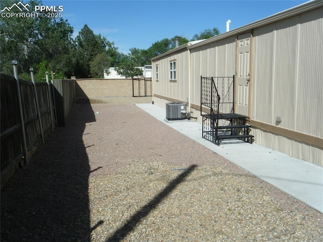 view of yard featuring central AC and a fenced backyard