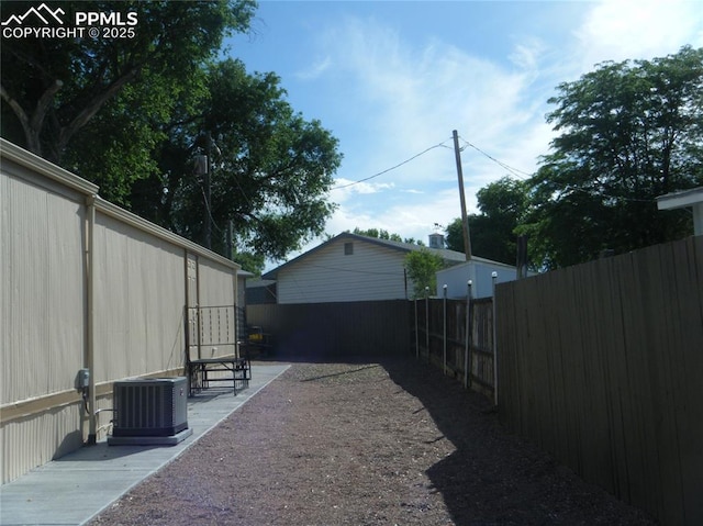 view of yard with a patio area, cooling unit, and fence