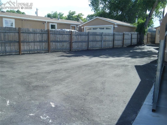 exterior space with a detached garage and fence