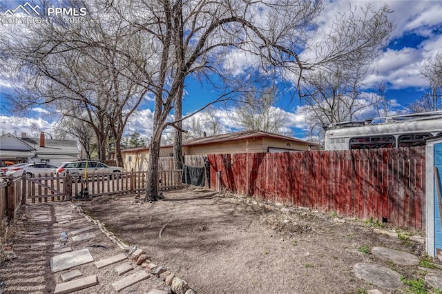 view of side of home featuring fence