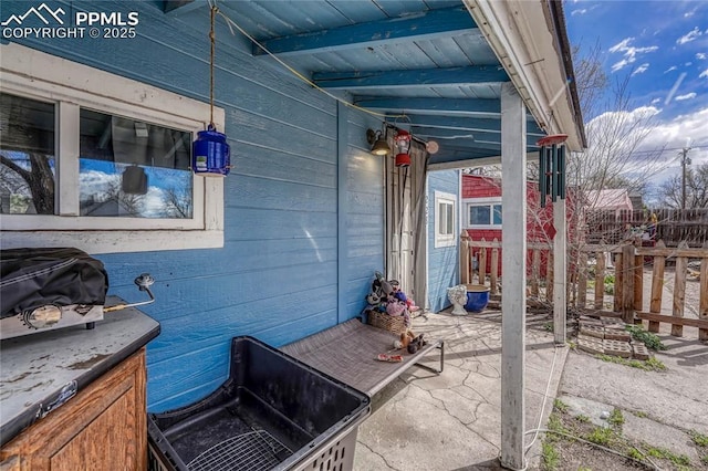 view of patio / terrace featuring fence