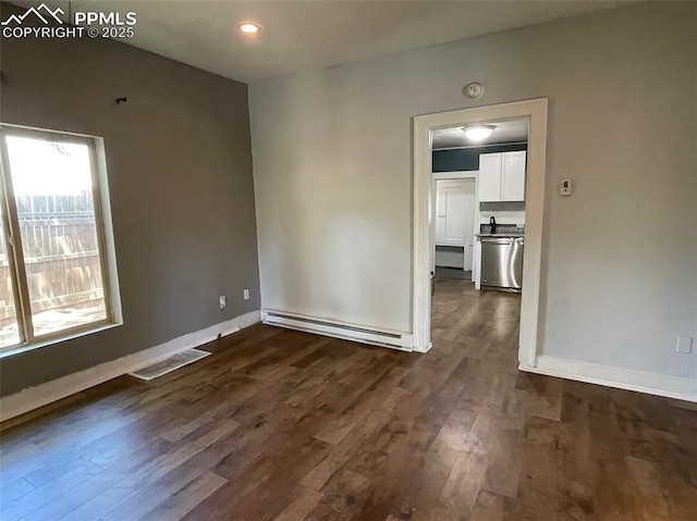 unfurnished room with visible vents, baseboards, baseboard heating, recessed lighting, and dark wood-style floors