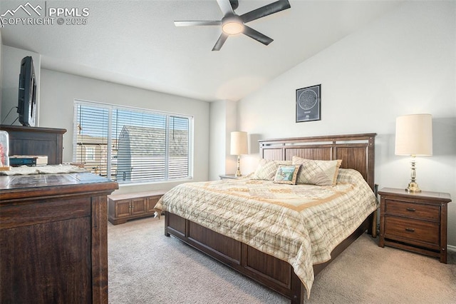 bedroom featuring vaulted ceiling, light colored carpet, and ceiling fan