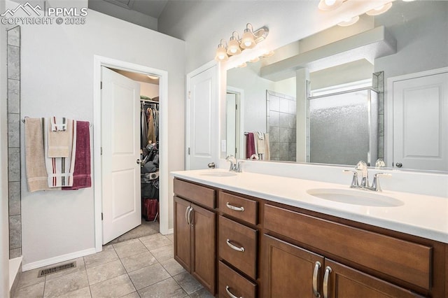 bathroom featuring vanity, tile patterned floors, and walk in shower