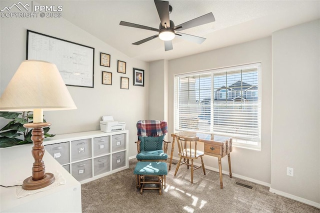 living area featuring carpet floors, lofted ceiling, a healthy amount of sunlight, and ceiling fan