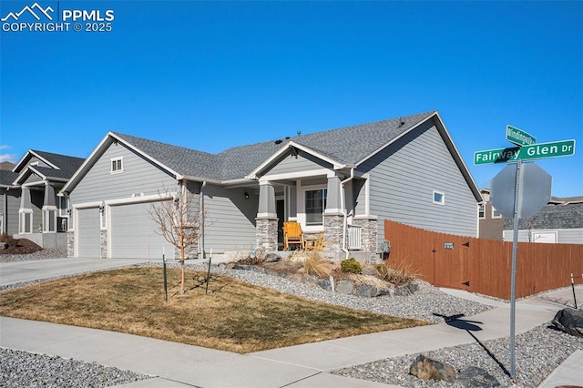 view of front of property with a garage, a front lawn, and covered porch