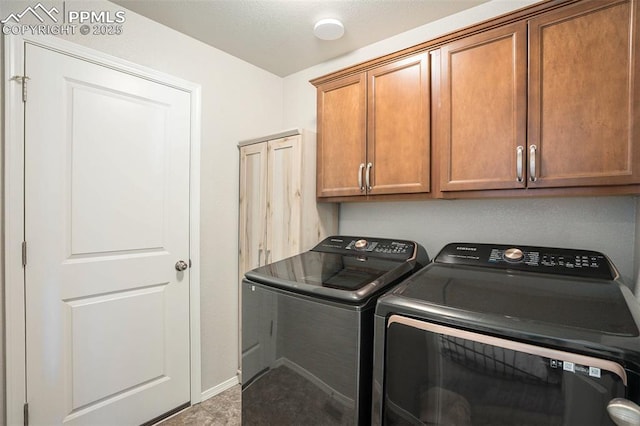 washroom featuring separate washer and dryer and cabinets