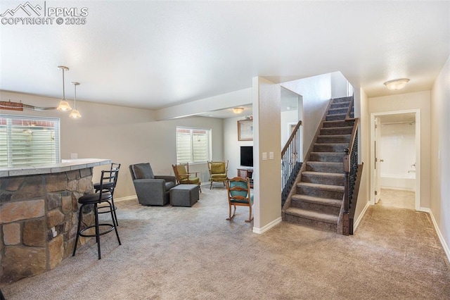 living room featuring plenty of natural light, light colored carpet, and bar area