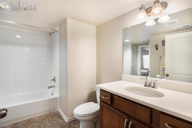 full bathroom with tiled shower / bath, vanity, and toilet