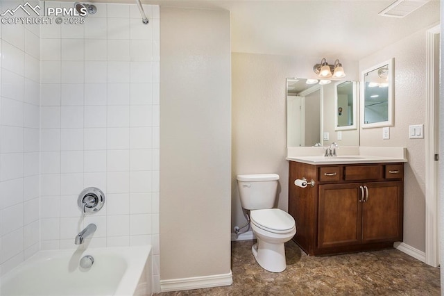 full bathroom with tiled shower / bath, vanity, and toilet