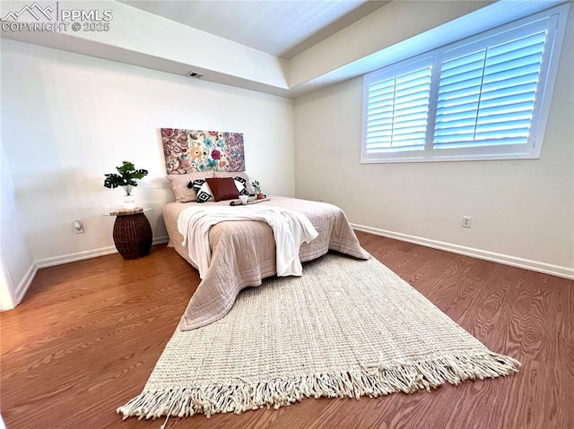 bedroom with wood-type flooring