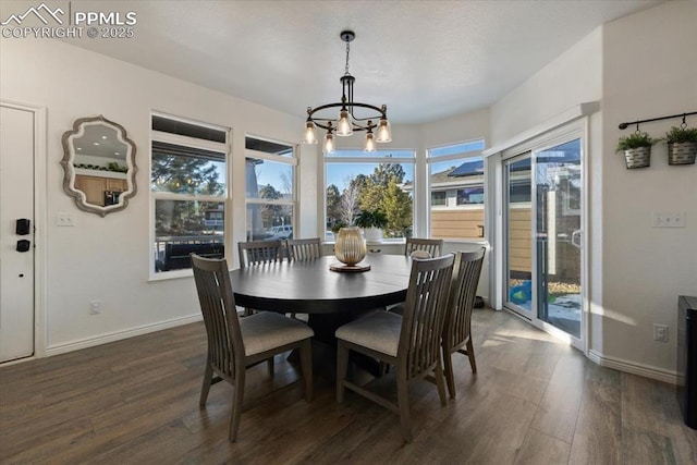 dining area with dark wood-type flooring and a chandelier