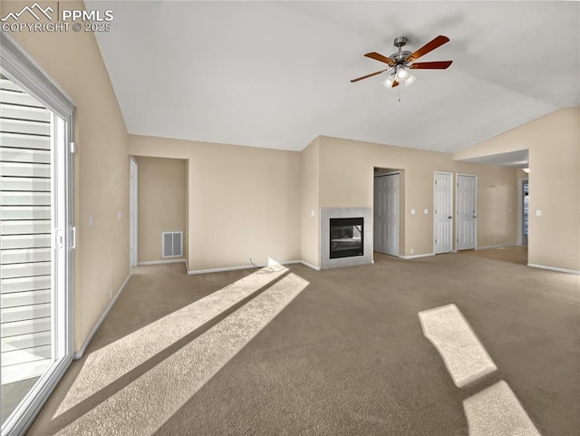 unfurnished living room featuring ceiling fan, carpet flooring, and vaulted ceiling