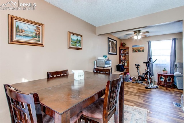 dining space with hardwood / wood-style flooring, ceiling fan, and a textured ceiling